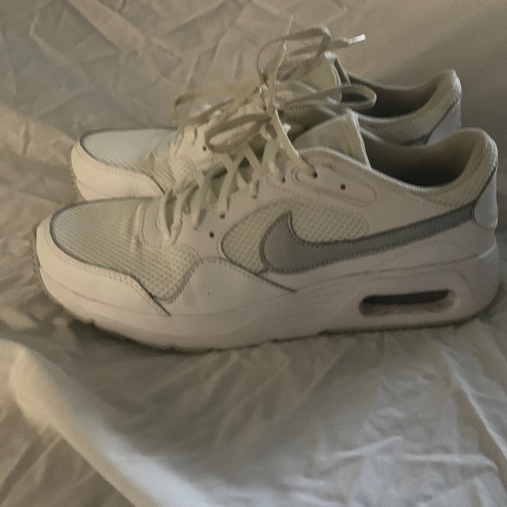 White and silver woman’s Nike shoes